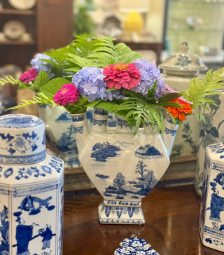 Decorative vases with floral arrangement on a wooden surface