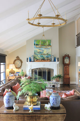 Living room with a fireplace, couch, and decorative items.